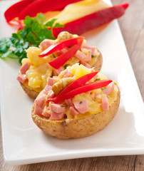 baked potato with sausages and salad