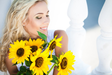 portrait of attractive woman with sunflowers in her hand