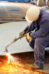 welder with protective mask welding metal