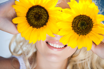 portrait of attractive woman with sunflowers in her hand