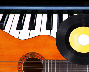 Guitar, piano and vinyl record.