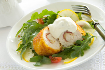Chicken breast with salad and tartare sauce.