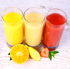 Oranges, bananas, strawberry slice, juice in glass