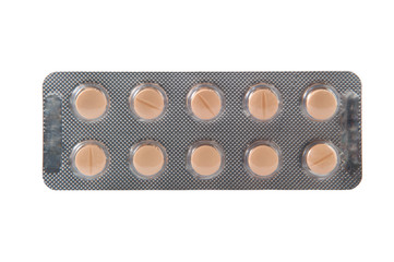 Orange tablet in blister pack on white background