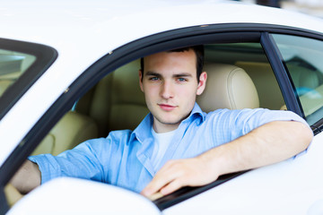 Young man sitting in car