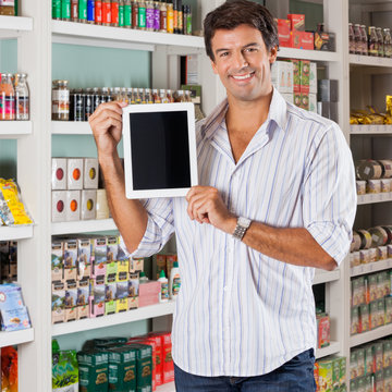 Man Showing Tablet In Supermarket