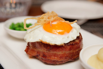 Tenderloin steak with fried egg and green pies