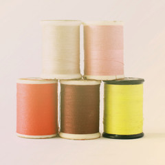 Different colors of thread spools with retro filter effect