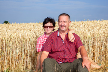 Woman and man sitting on the wheat field