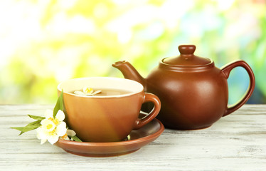 Cup of tea with jasmine, on bright background