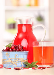 Pitcher and glass of cranberry juice with red cranberries