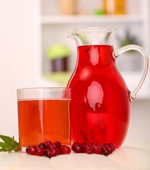 Pitcher and glass of cranberry juice with red cranberries