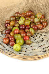 Fresh gooseberries on wicker mat close-up