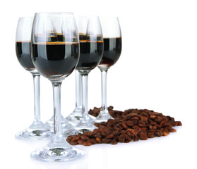 Glasses of liquor and coffee grains, isolated on white