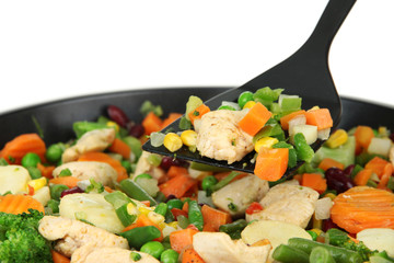 Casserole with vegetables and meat on pan, isolated on white