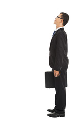 full length businessman standing and looking