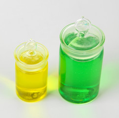 Bottles with colored liquids isolated on white
