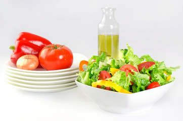 fresh salad and vegetables in white plates