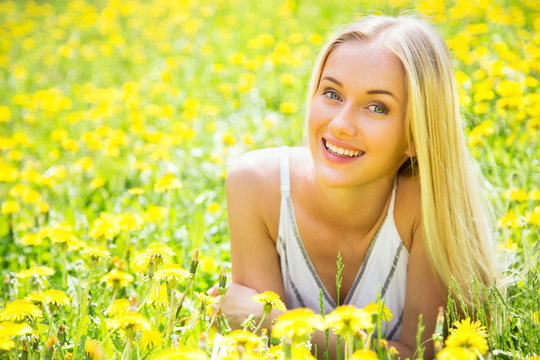Beautiful young woman among the flowers