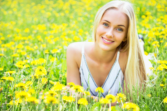 Beautiful young woman among the flowers