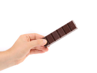 Hand holds dark chocolate bar.