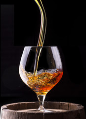 Cognac or brandy on a wooden barrel