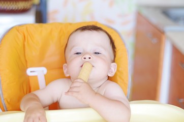 baby age of 10 months eats cookie