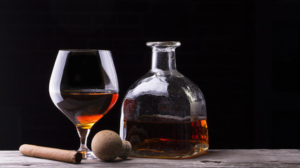 Cognac and Cigar on black with vintage table