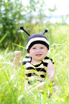 baby in bee costume outdoors