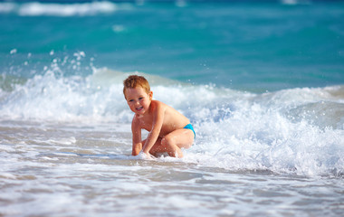 happy boy kid having fun in sea water