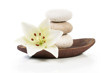 spa decoration with stones and lily on a wooden plate