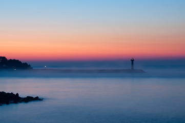 Silhouette of lighthouse before sunrise