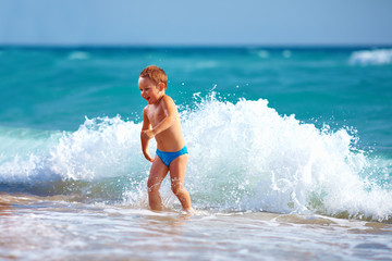 happy boy kid having fun in sea water
