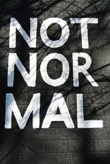 Not normal sign painted on the wall