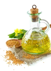 Fotobehang Jar of mustard oil and seeds with mustard flower, isolated © Africa Studio
