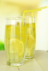 Delicious lemonade on table on light background