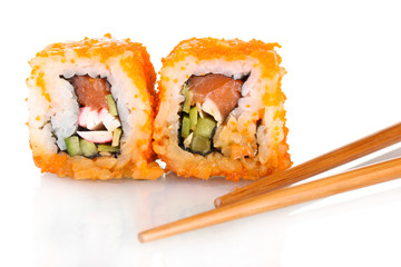 delicious sushi and chopsticks isolated on white