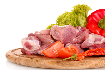 Pieces of raw meat and vegetables