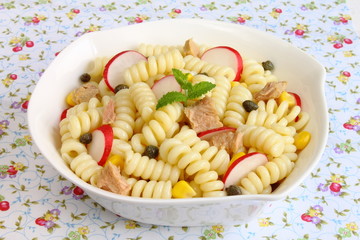 Pasta salad with radish, capers, sweet corn and tuna fish