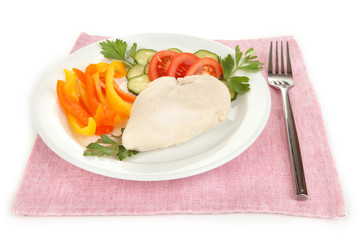 Boiled chicken breast on plate with vegetables close up
