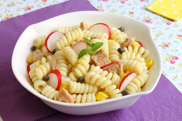Pasta salad with radish, capers, sweet corn and tuna fish