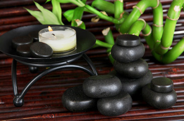 Obraz na płótnie Canvas Spa stones and bamboo on bamboo mat background