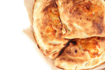 Pizza calzones on tracing paper isolated on white