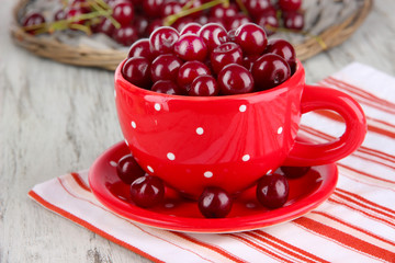 Sweet cherry in cup on table close-up