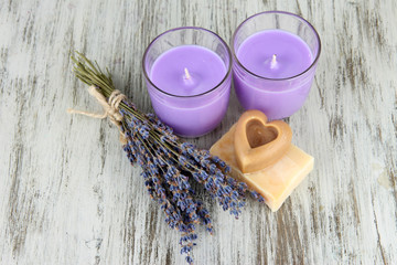 Obraz na płótnie Canvas Lavender candle with fresh lavender, soap on wooden background