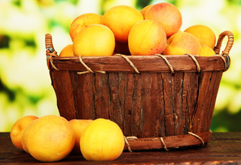 Fresh natural apricot in basket on wooden table