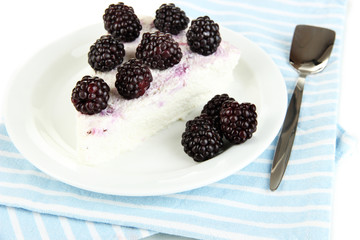 Cheesecake with fresh berries on white plate closeup