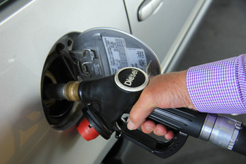 Pumping gas at a gas station