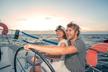 Young couple navigating on a yacht