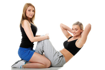 Obraz na płótnie Canvas Two women doing fitness exercise isolated